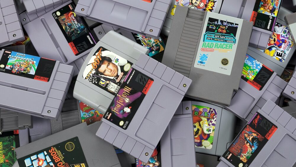 A large pile of loose NES, SNES, and N64 cartridges — condition and completeness drive their value
